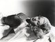 Lana Turner lying down in a black dress photo print.