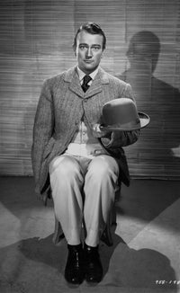 John Wayne seated holding his hat photo print