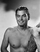 Johnny Weissmuller Portrait Photo Print holding a tree trunk.