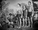 Johnny Weissmuller standing with family and monkey in a movie scene photo print