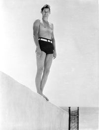Johnny Weissmuller standing on a diving board photo print.