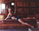 Tuesday Weld lying on a brown couch photo print