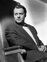 Orson Welles seated in coat and bowtie photo print.