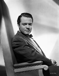 Orson Welles seated in a formal suit photo print