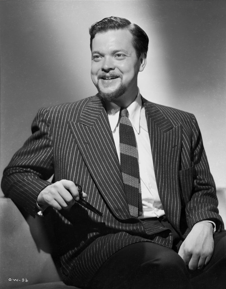 Orson Welles smiling in coat and tie photo print.