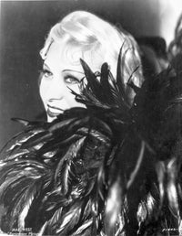 Mae West smiling in a feather dress photo print.