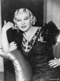 Mae West photo print in black dress with hand on hips.