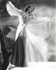 Loretta Young in a white long dress standing by a dead tree - photo print