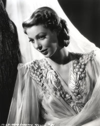 Loretta Young in a crepe white dress with sheer sleeves photo print