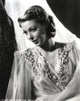 Loretta Young in a crepe white dress with sheer sleeves photo print