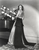 Loretta Young in elegant long gown with black ribbon photo print.