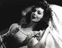 Loretta Young lying in bed photo print with curly hair.