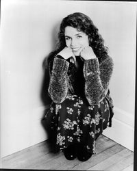 Megan Gallagher black and white photo print in sweater and floral skirt