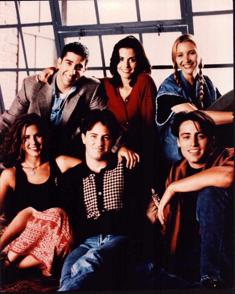 Friends cast photo print in front of windows, 8x10 size.