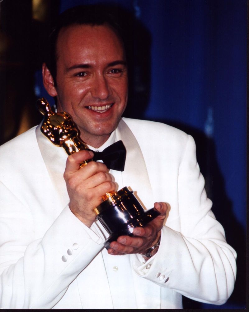 Kevin Spacey in white tuxedo holding Oscar Award photo print