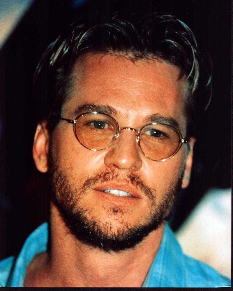 Val Kilmer close-up photo print in blue top and glasses.