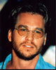 Val Kilmer close-up photo print in blue top and glasses.