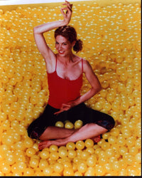 Jenna Elfman doing yoga in a yellow ball pit - photo print