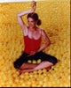Jenna Elfman doing yoga in a yellow ball pit - photo print