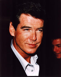 Close-up photo print of Pierce Brosnan in a black blazer and unbuttoned shirt.