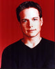 Scott Wolf photo print in black sweater with red background.