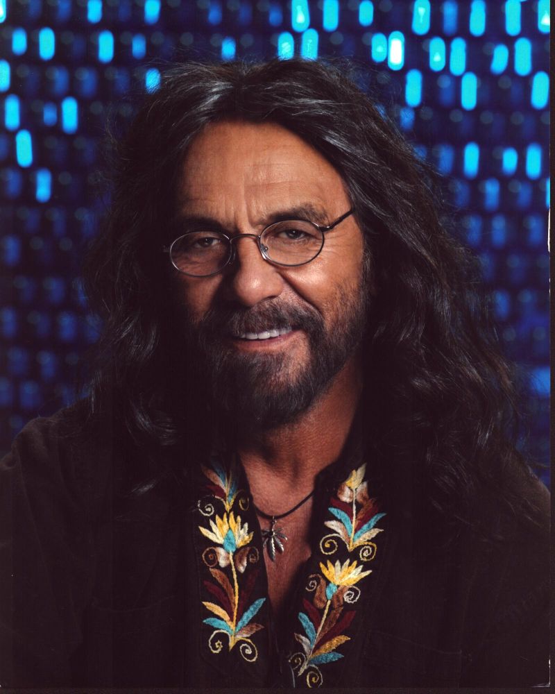 Tommy Chong photo print in brown shirt with floral trim.