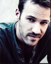 Close-up photo print of Falk Hentschel in a gray shirt.