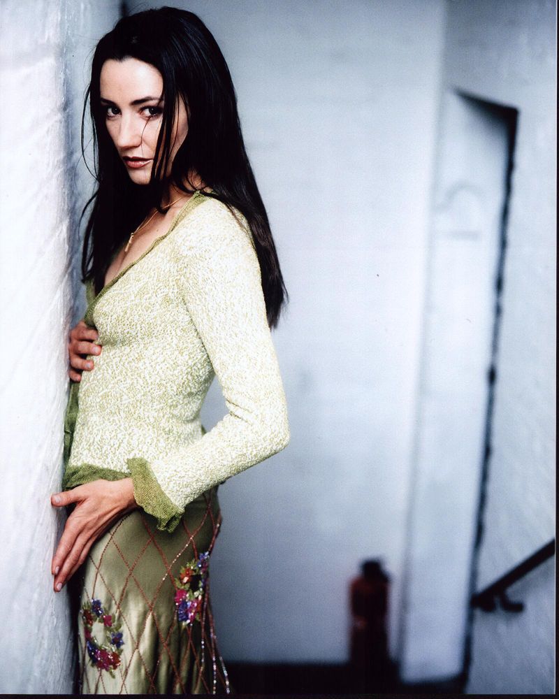 Orla Brady photo print in green sweater against wall