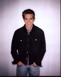 Billy Aaron Brown photo print in black denim jacket and jeans.