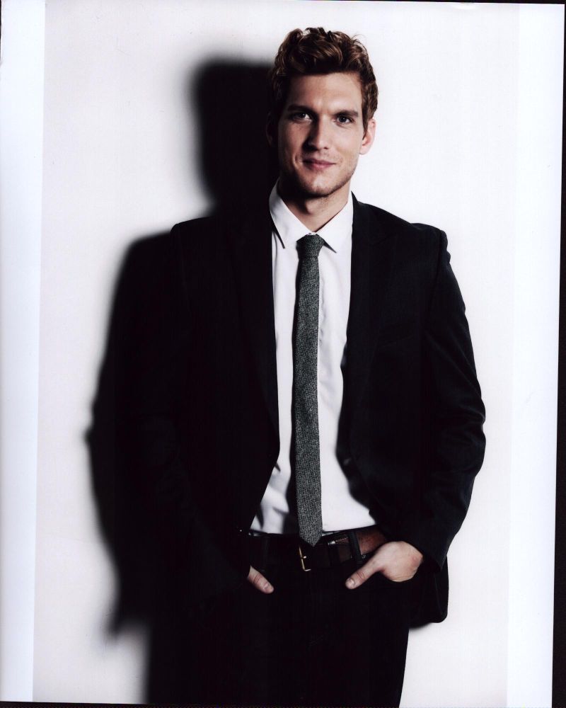 Scott Michael Foster in black suit with gray tie photo print.