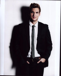 Scott Michael Foster in black suit with gray tie photo print.