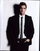 Scott Michael Foster in black suit with gray tie photo print.