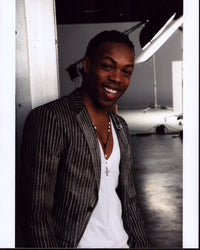 Todrick Hall leaning against wall in striped jacket photo print