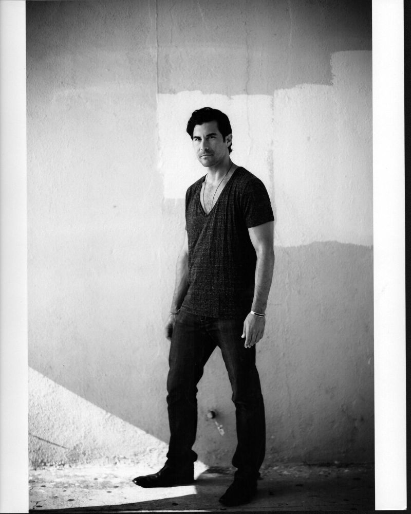 David Desantos black and white photo print in jeans and shirt.