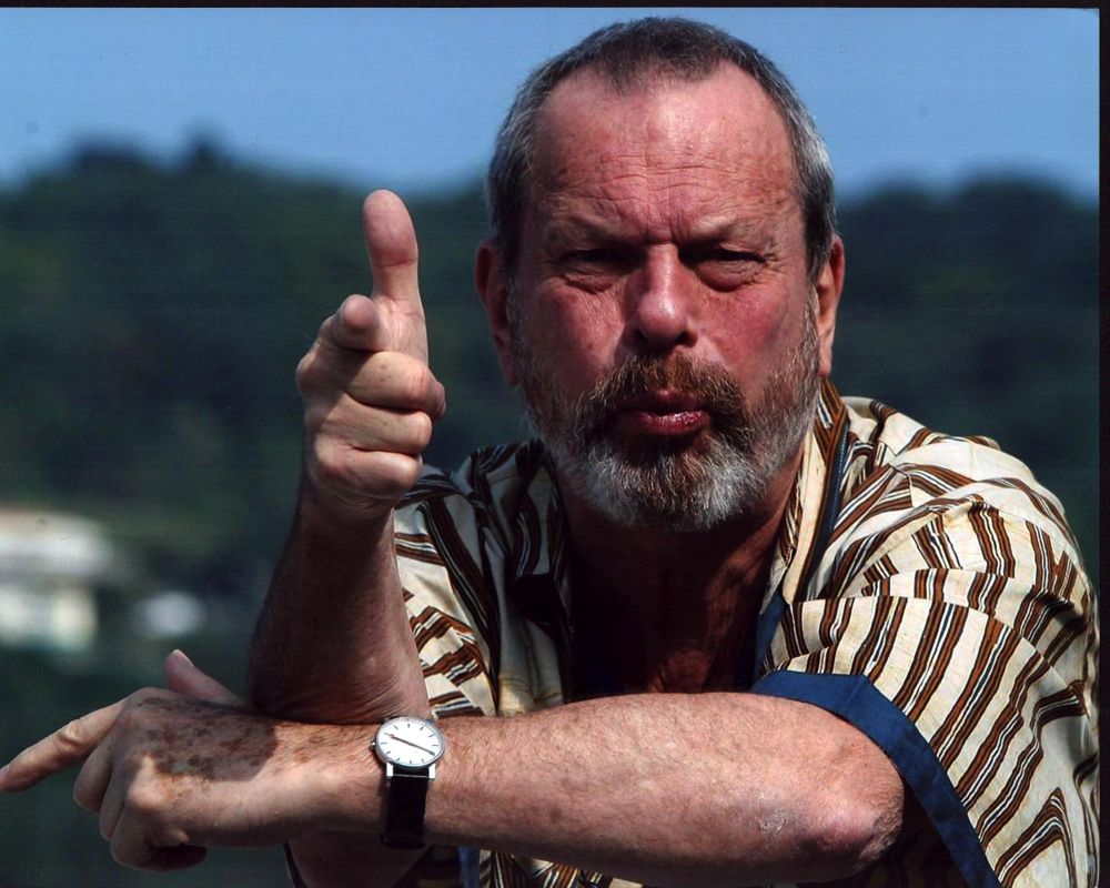 Photo print of Terry Gilliam doing finger guns in a striped shirt.
