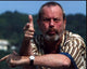 Photo print of Terry Gilliam doing finger guns in a striped shirt.