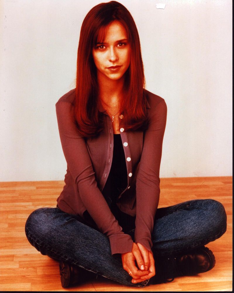 Jennifer Love Hewitt sitting on the floor in a cozy sweater and jeans photo print.