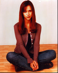 Jennifer Love Hewitt sitting on the floor in a cozy sweater and jeans photo print.