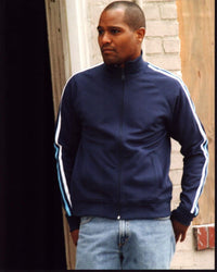 Seth Gilliam leaning against wall in blue jacket photo print.