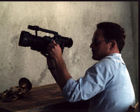 Cole Hauser photo print in sunglasses holding a video camera.
