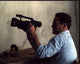 Cole Hauser photo print in sunglasses holding a video camera.