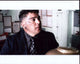 Nicholas Turturro in black jacket and checkered tie photo print.