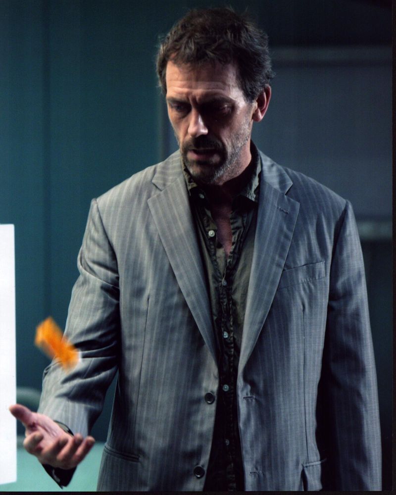 Hugh Laurie photo print tossing a pill bottle, available in multiple sizes.