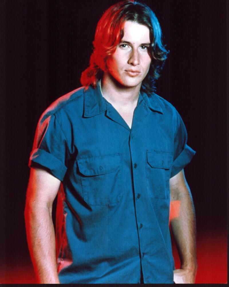 Brendan Fehr photo print in short sleeve button down with red and black background.