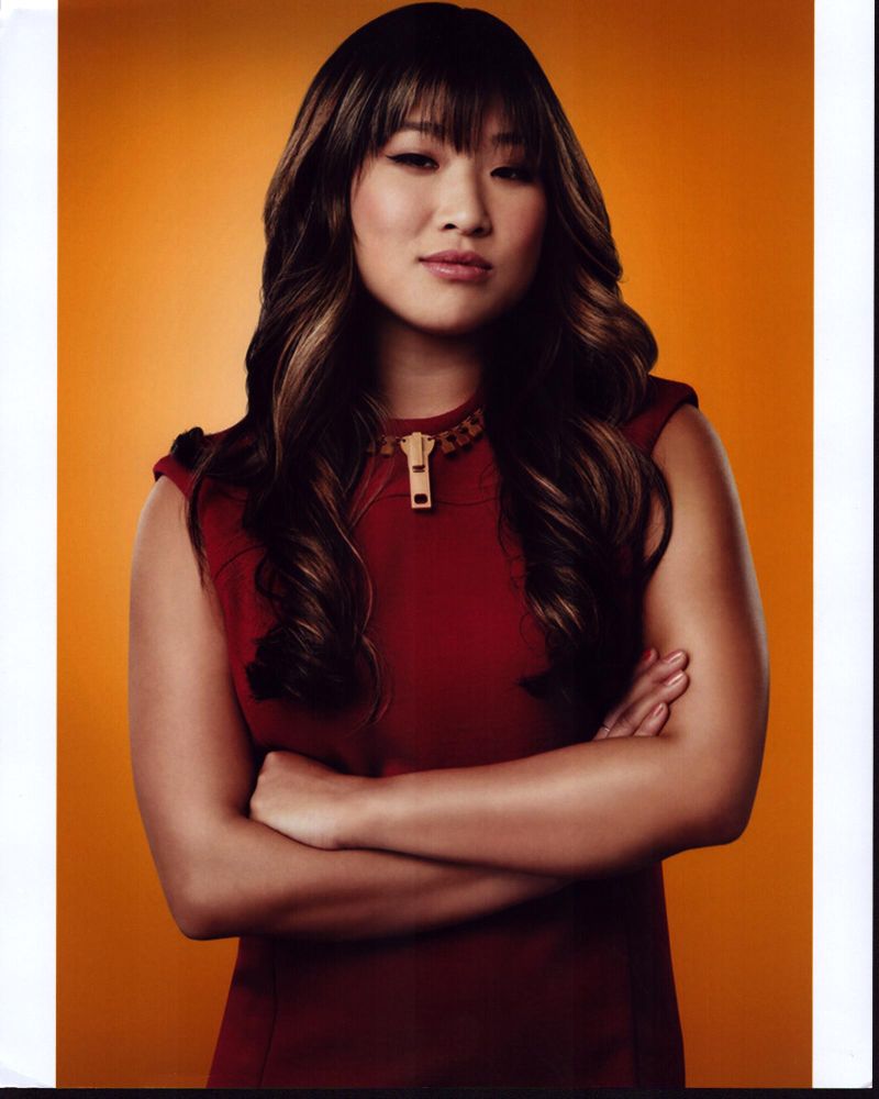 Jenna Ushkowitz arms crossed photo print with yellow background.