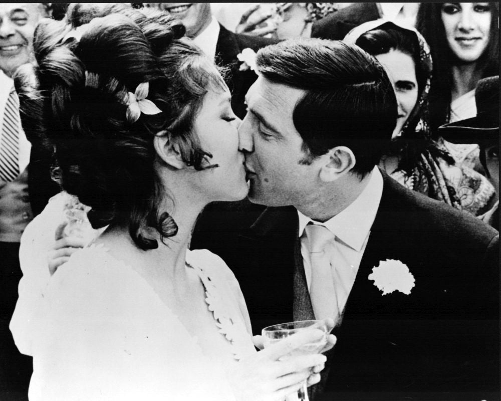 Diana Rigg kissing George Lazenby at an event for On Her Majesty's Secret Service photo print