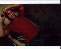 Lucien Laviscount laying in cot next to a bloody wall photo print