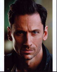 Derek Wilson headshot photo print in black jacket.