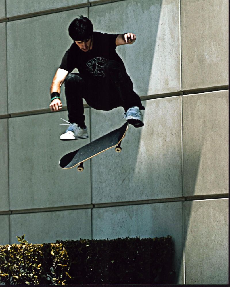 Chris Cole doing a kickflip photo print action shot.