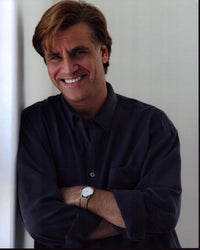 Aaron Sorkin smiling leaning against a wall photo print